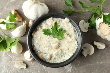 Concept of tasty food with mushroom sauce on gray textured background
