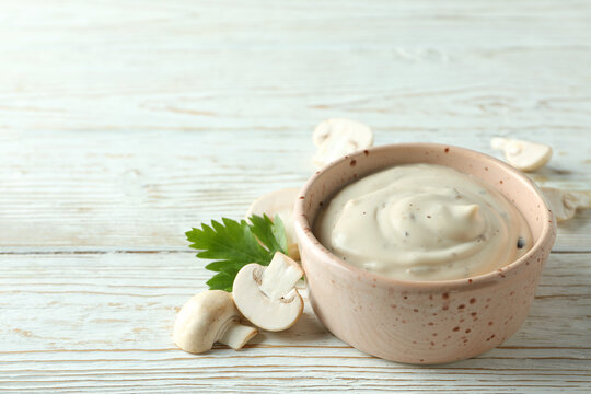 Concept of tasty food with mushroom sauce on white wooden background