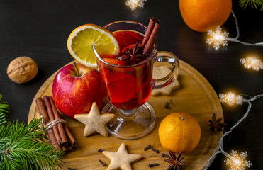 Christmas mulled wine and tangerines on a wooden background.
