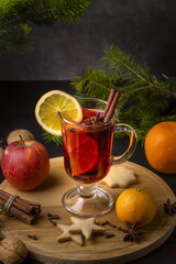 Christmas mulled wine and tangerines on a wooden background.