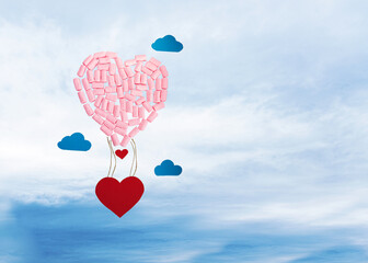 Fototapeta na wymiar hot air balloon made of marshmallows and red hearts, background of clouds and sky. Creative greeting card for valentine's day. Sweets