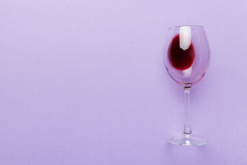One glasses of red wine at wine tasting. Concept of red wine on colored background. Top view, flat lay design