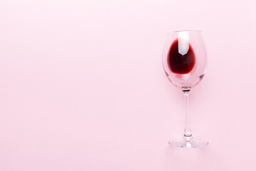 One glasses of red wine at wine tasting. Concept of red wine on colored background. Top view, flat lay design