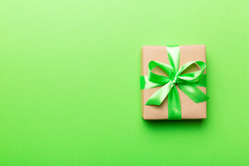 Holiday present box over colored background, top view. Copy space for design