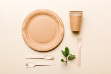set of empty reusable disposable eco-friendly plates, cups, utensils on light white colored table background. top view. Biodegradable craft dishes. Recycling concept. Close-up