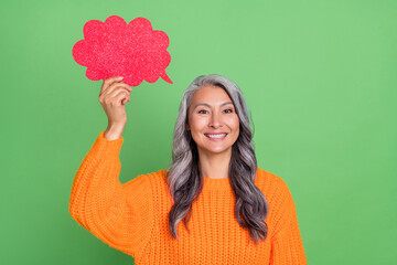 Photo of cute grey hairdo elder lady speak wear orange pullover isolated on green background