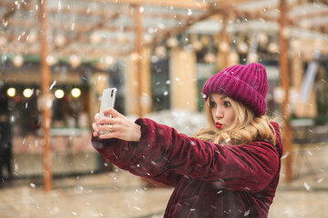 Flirty lady taking self portrait at the holiday fair