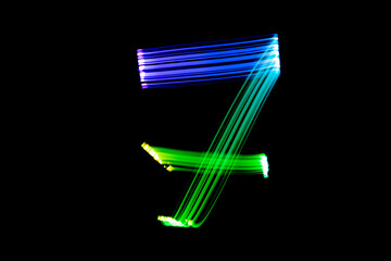 Freezelight photography. Isolated figure on a black background. Number seven.