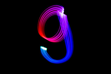 Freezelight photography. Isolated figure on a black background. Number nine.
