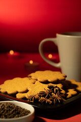 A pile of homemade gingerbread cookies on a plate against the festive background.