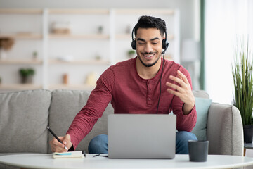 Excited arab guy attending online training from home