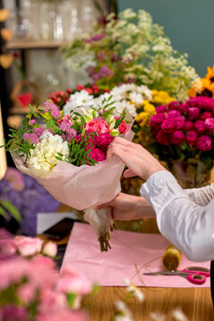 People, Shopping, Sale, Floristry And Consumerism Concept. Close-up Female Hands Giving Flowers To Customer At Flower Shop. Beautifully Made Prepared Bouquet On 8 March Or Another Holiday