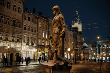 Fototapeta premium FOUNTAIN WITH A SCULPTURE FIGURE OF DIANA. Sculpture Covered In Snow.