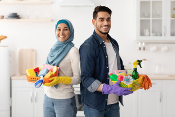 Happy muslim family cleaning their new apartment