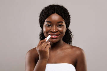 Chapped Lips Prevention. Beautiful Black Lady Using Chapstick And Smiling At Camera