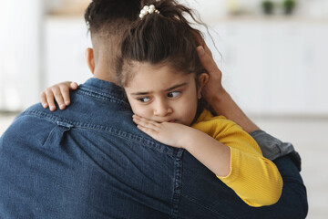 Closeup Portrait Of Upset Little Girl Hugging Daddy At Home
