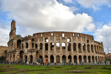 Fototapeta na wymiar Colosseum in Rome, Italy on a sunny day, walking on ancient step-ways of the Roman Empire