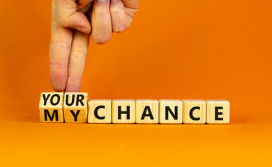 Your or my chance symbol. Businessman turns wooden cubes and changes words 'my chance' to 'your chance'. Beautiful orange background, copy space. Business and your or my chance concept.