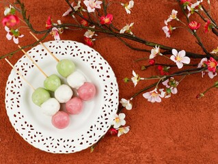 Obraz na płótnie Canvas Sanshoku Dango Japanese Mochi, Pink, White, and Green Colored Dumplings. Three Colored Cherry Blossom Hanami Dango Traditional Japan Sweet