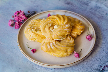 Home made eclairs with vanilla cream in a plate 