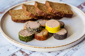 Bread and  different type pate in a plate 