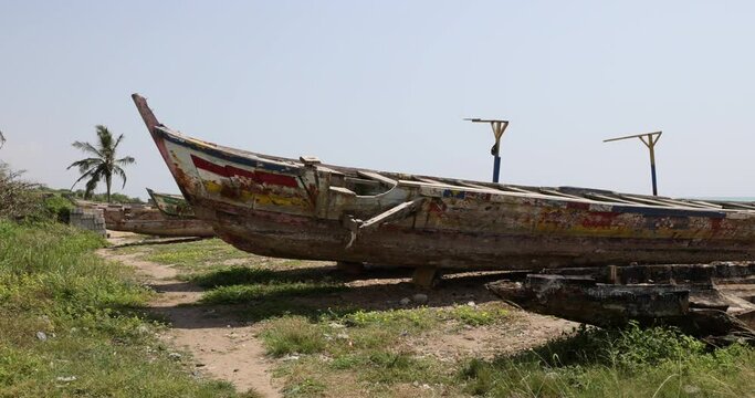 Traditional wood fishing boats beach Atlantic ocean Ghana. West Africa on the Atlantic ocean. Traditional fishing fleet handmade wooden boats, colorful paint. Nets and line fishing.