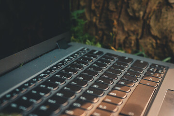 Laptop computer left out in nature during golden hour