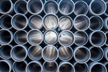 Background of grey plastic sewage pipes used at the building site. Texture and pattern of plastic...
