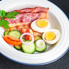 English breakfast bacon, egg, tomato, cucumber, toast bread healthy meal diet snack on the table copy space food background rustic. top view