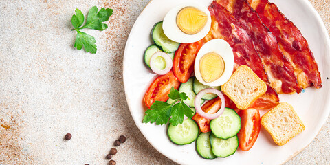 English breakfast bacon, egg, tomato, cucumber, toast bread healthy meal diet snack on the table copy space food background rustic. top view