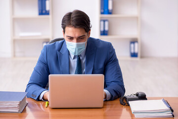 Young businessman employee working in the office during pandemic