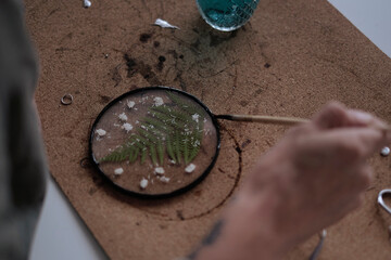 woman fixes glass plates. A picture of dried flowers. Master class on creating frame. be more creatively engaged. A Life of Happiness and Fulfillment