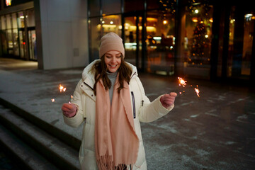 Caucasian white girl with sparklers Christmas shopping. High quality photo