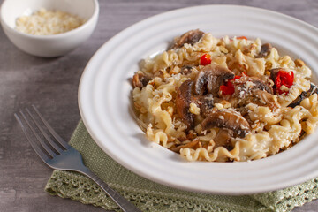 Homemade curly pasta with mushrooms and parmesan cheese