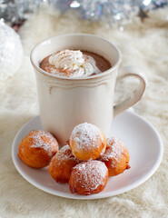 Sweet small donuts with hot chocolate on winter table