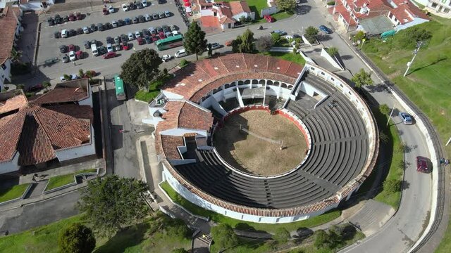 360 degree aerial shot of the coliseum or open air theater in Guatavita, Colombia, on a sunny day