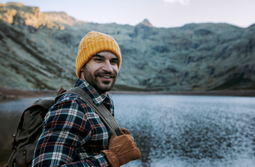Man with cap and gloves in the mountains