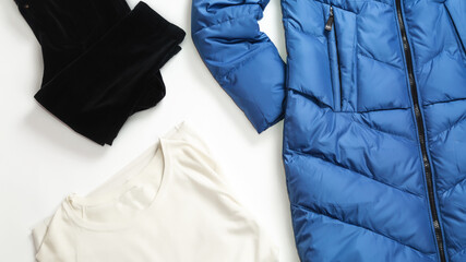 A set of warm autumn-winter clothes for a women on a white background. Jacket , trousers, jumper . Flat lay. top view