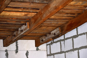 Two beams and planks on the roof of the house.