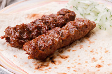 lula kebab on pita bread with pickled onions