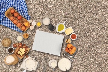 New Year in the kitchen.  A piece of dough, eggs and a wooden rolling pin lies on a granite countertop