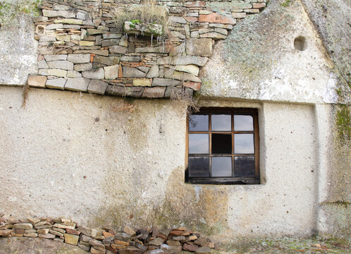 Old stone house with littl squered windows