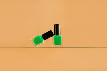 Green nail polish isolated on a beige background. Preparation for St. Patrick's Day.
