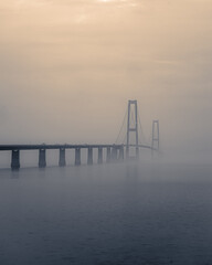 Fototapeta na wymiar Storebealt Bridge in the mist, in Denmark between Nyborg and Korsor.