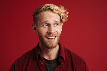 White bearded man wearing shirt smiling and looking at camera