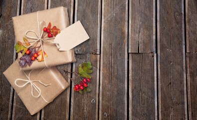 Beautiful gift box with ribbon on wood background, decorative container for putting presents in.