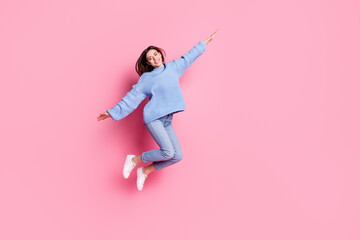Full length body size view of attractive cheery girly girl jumping having fun isolated over pink pastel color background