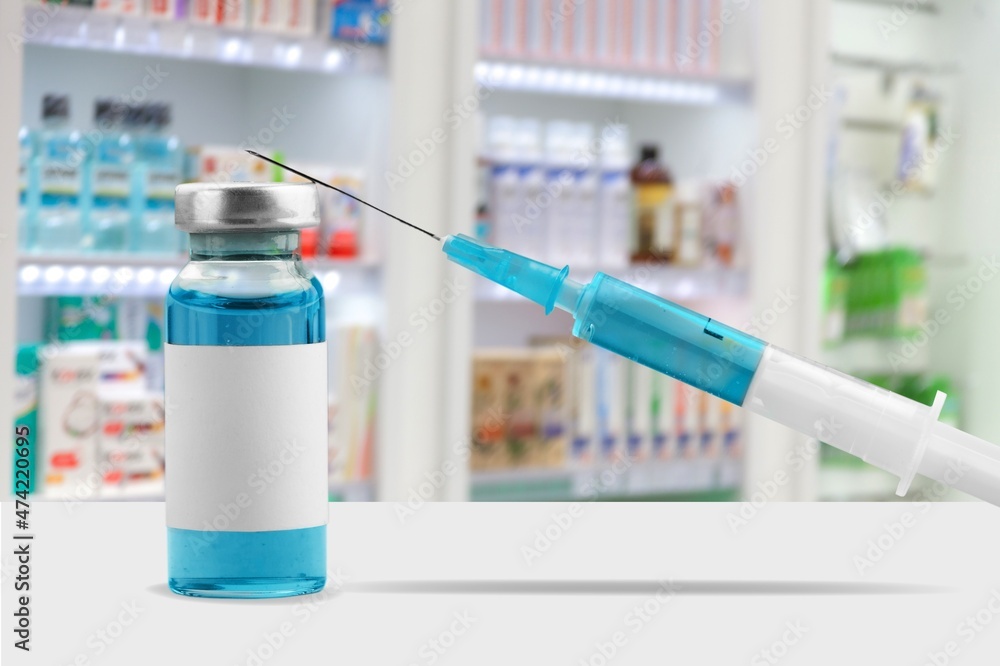 Wall mural Syringe and vaccine bottle on background. healthcare and hospital.