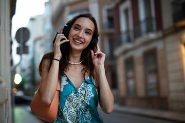 Beautiful young elegance woman using the phone. Beautiful fashion woman listening the music..