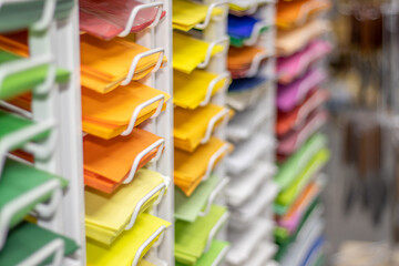 shelves with colorful paper in an art store. art shop with white stand. craft, handmade. art tool for kids, artist, pictures, painters.